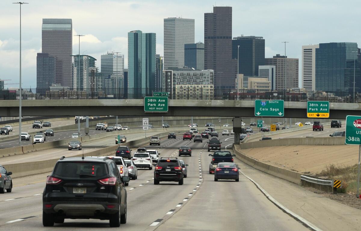 FILE - Motorists drive on southbound Interstate 25 with the city skyline in the background April 30, 2026, in Denver. (AP Photo/David Zalubowski, File)
