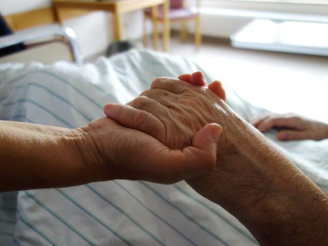nurse holding a hand of a patient