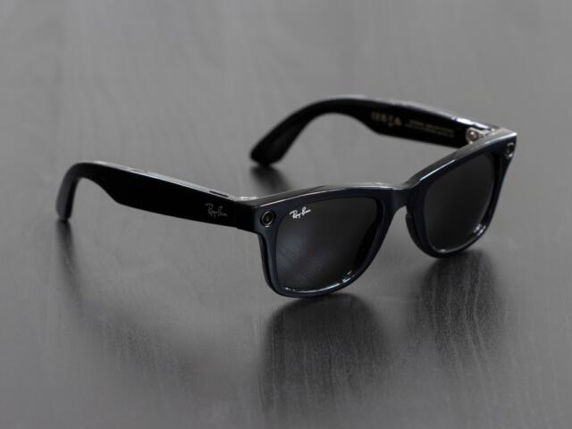 Portland, OR, USA - Dec 5, 2023: A pair of new Ray-Ban Meta Wayfarer smart glasses isolated on a dark gray background.