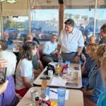 Gov. JB Pritzker speaks with Emily Waugh of Oregon at Lulu’s Diner in Springfield on Thursday, Aug. 27, 2026. (Capitol News Illinois photo by Ben Szalinski)