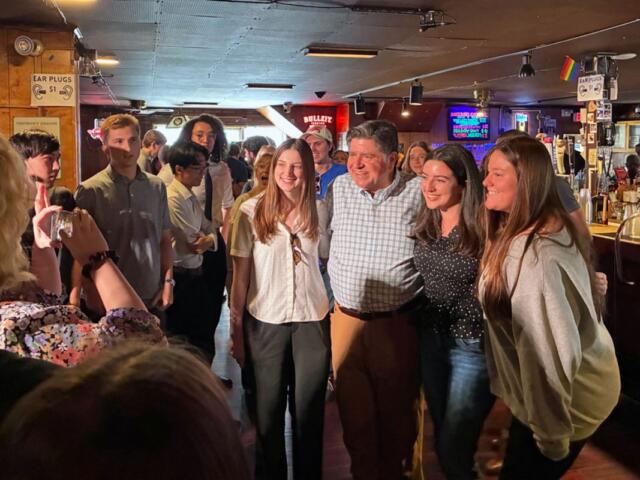 Gov. JB Pritzker takes a picture with University of Illinois students at Rose Bowl Tavern in Urbana on Thursday, Aug. 27, 2026. (Capitol News Illinois photo by Ben Szalinski)