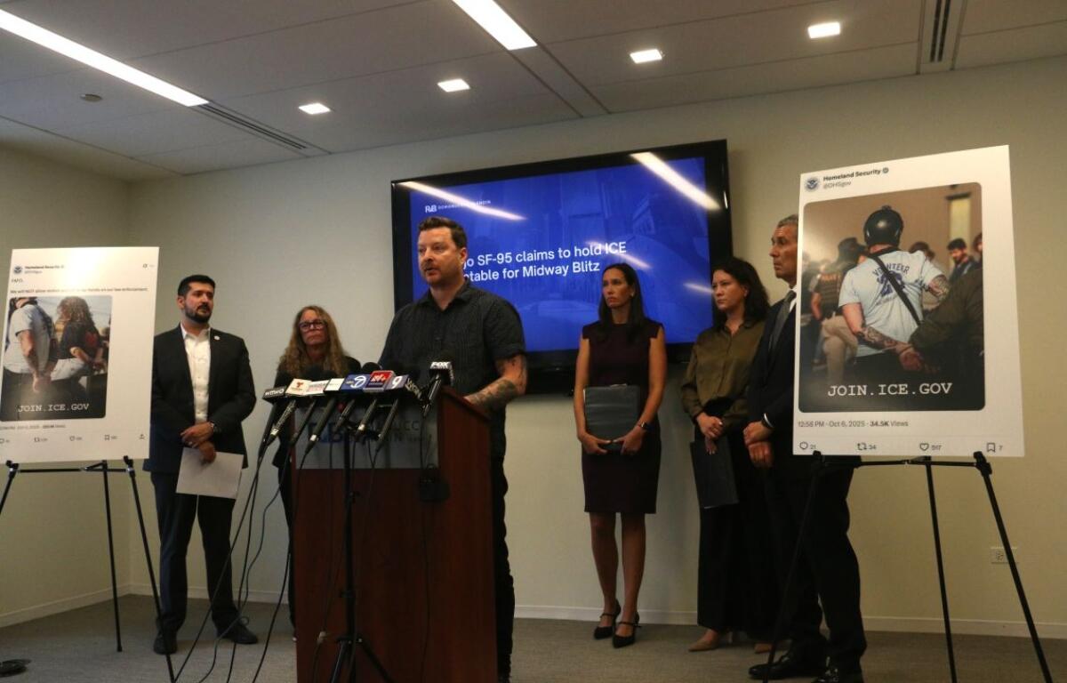 Harvard data scientist Kyle Frankovich stands at a Sept. 17, 2026, news conference between photos of Department of Homeland Security social media posts using images of him with his arms zip-tied behind his back after protesting at the Broadview immigration detention center. (Capitol News Illinois photo by Maggie Dougherty