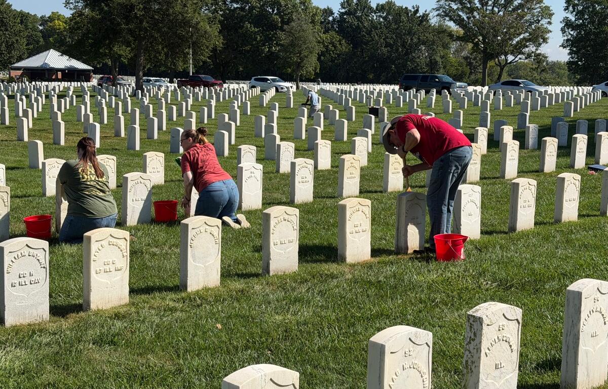 Volunteers clean headstones at Camp Butler National Cemetery Saturday, September 12.