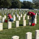 Volunteers clean headstones at Camp Butler National Cemetery Saturday, September 12.