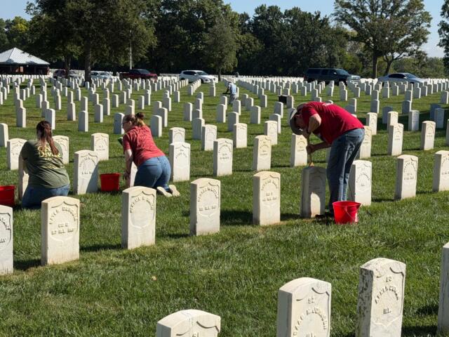 Volunteers clean headstones at Camp Butler National Cemetery Saturday, September 12.