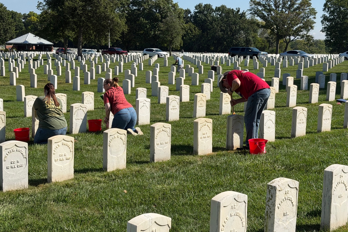 Volunteers clean headstones at Camp Butler National Cemetery Saturday, September 12.