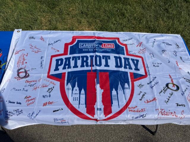 Volunteers at Camp Butler National Cemetery Saturday, September 12 signed a 'Patriot Day' banner provided by Carry the Load.