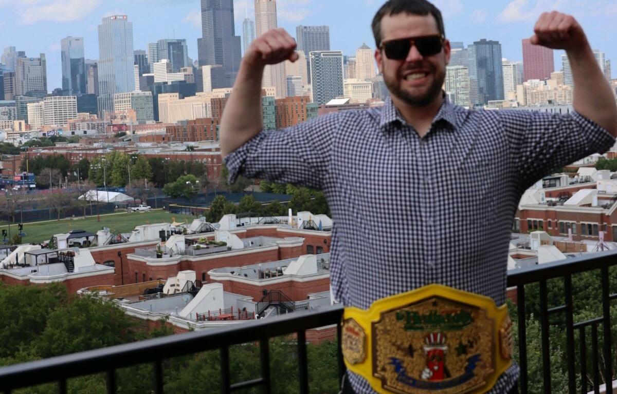 Patrick Bertoletti shows off his Nathan's Hot Dog Eating championship belt in Chicago, his home town.
