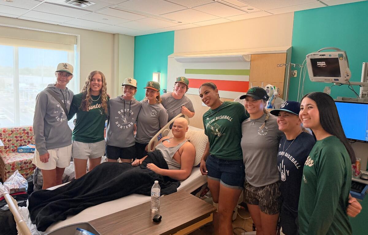 Players in the Women's Professional Baseball League visit with one of the patients of HSHS St. John's Children's Hospital Thursday, September 3.