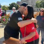 Ross Horne, Ride to Remember organizers, share an embrace with Springfield Mayor Misty Buscher, after she received a special appreciation plaque from the Springfield Salvation Army.
