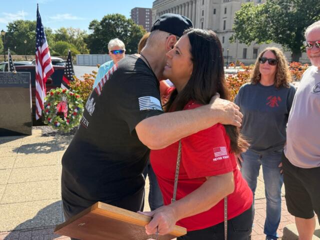 Ross Horne, Ride to Remember organizers, share an embrace with Springfield Mayor Misty Buscher, after she received a special appreciation plaque from the Springfield Salvation Army.