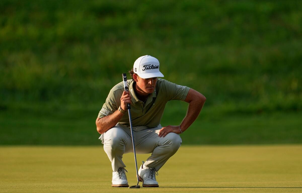 Jackson Koivun lines up his ball on the first green during the first round of the St. Jude Championship golf tournament, Thursday, Aug. 13, 2026, in Memphis, Tenn. (AP Photo/George Walker IV)