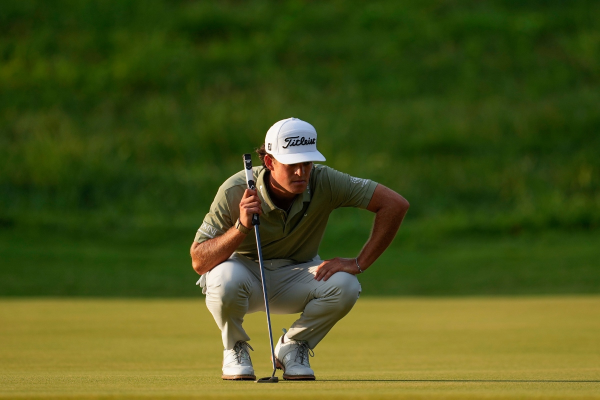 Jackson Koivun lines up his ball on the first green during the first round of the St. Jude Championship golf tournament, Thursday, Aug. 13, 2026, in Memphis, Tenn. (AP Photo/George Walker IV)