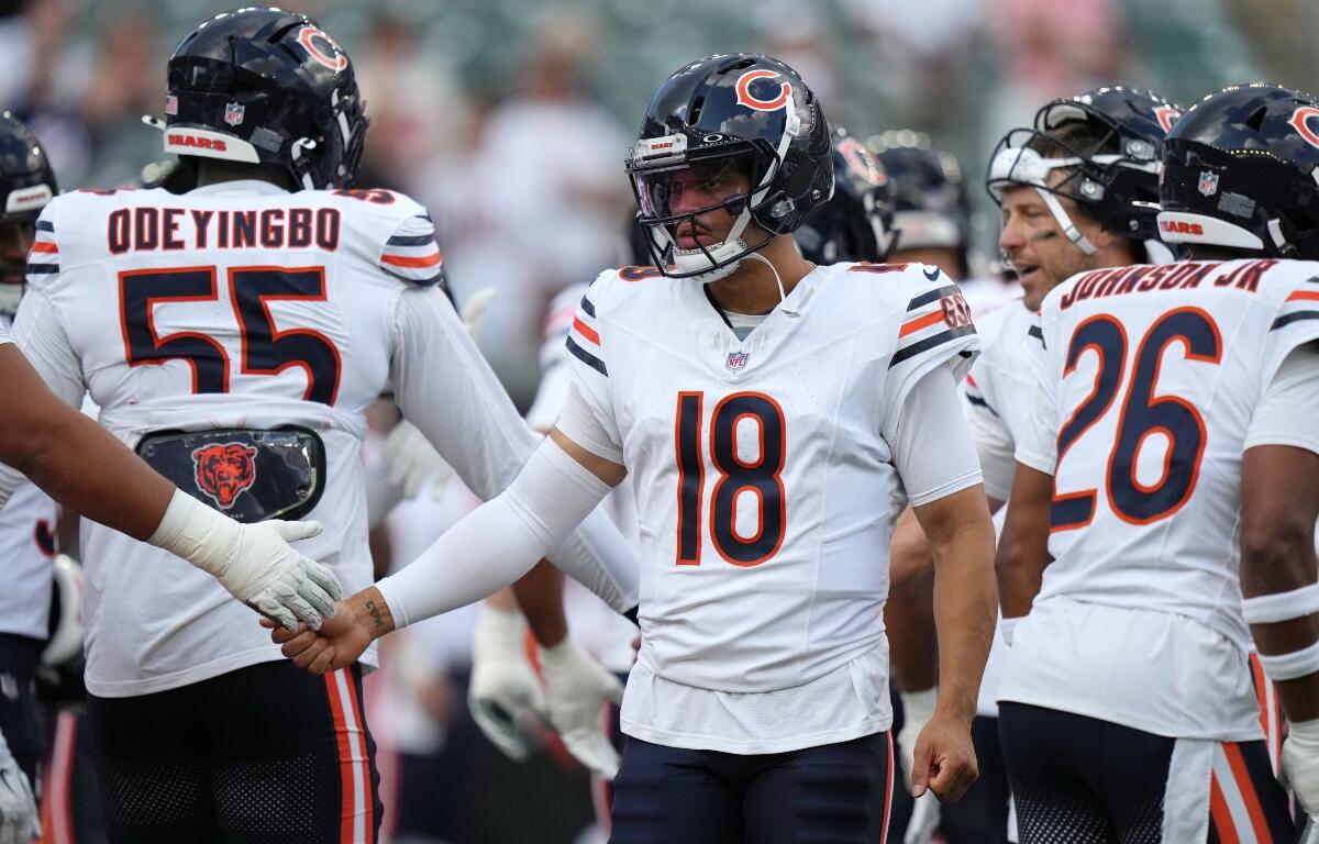Chicago Bears quarterback Caleb Williams, center, greets players during warm ups before a preseason NFL football game against the Cincinnati Bengals on Saturday, Aug. 22, 2026, in Cincinnati. (AP Photo/Joshua A. Bickel)