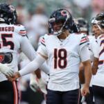 Chicago Bears quarterback Caleb Williams, center, greets players during warm ups before a preseason NFL football game against the Cincinnati Bengals on Saturday, Aug. 22, 2026, in Cincinnati. (AP Photo/Joshua A. Bickel)