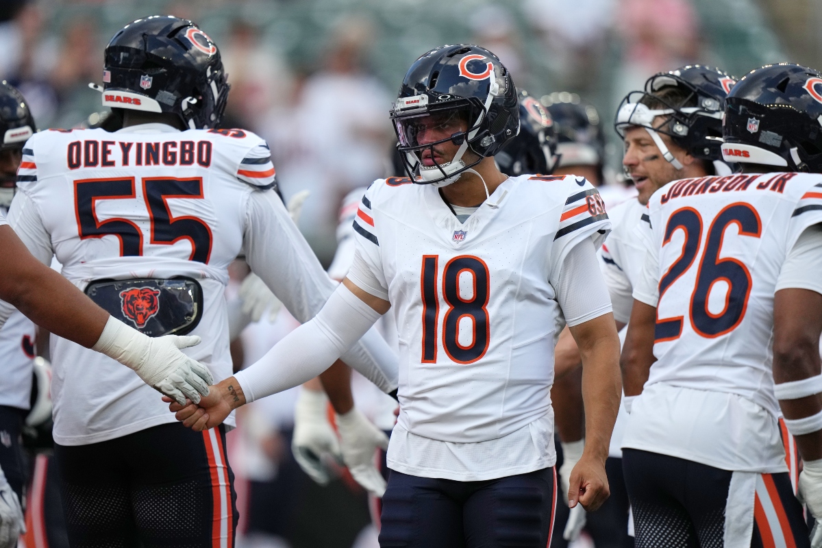 Chicago Bears quarterback Caleb Williams, center, greets players during warm ups before a preseason NFL football game against the Cincinnati Bengals on Saturday, Aug. 22, 2026, in Cincinnati. (AP Photo/Joshua A. Bickel)