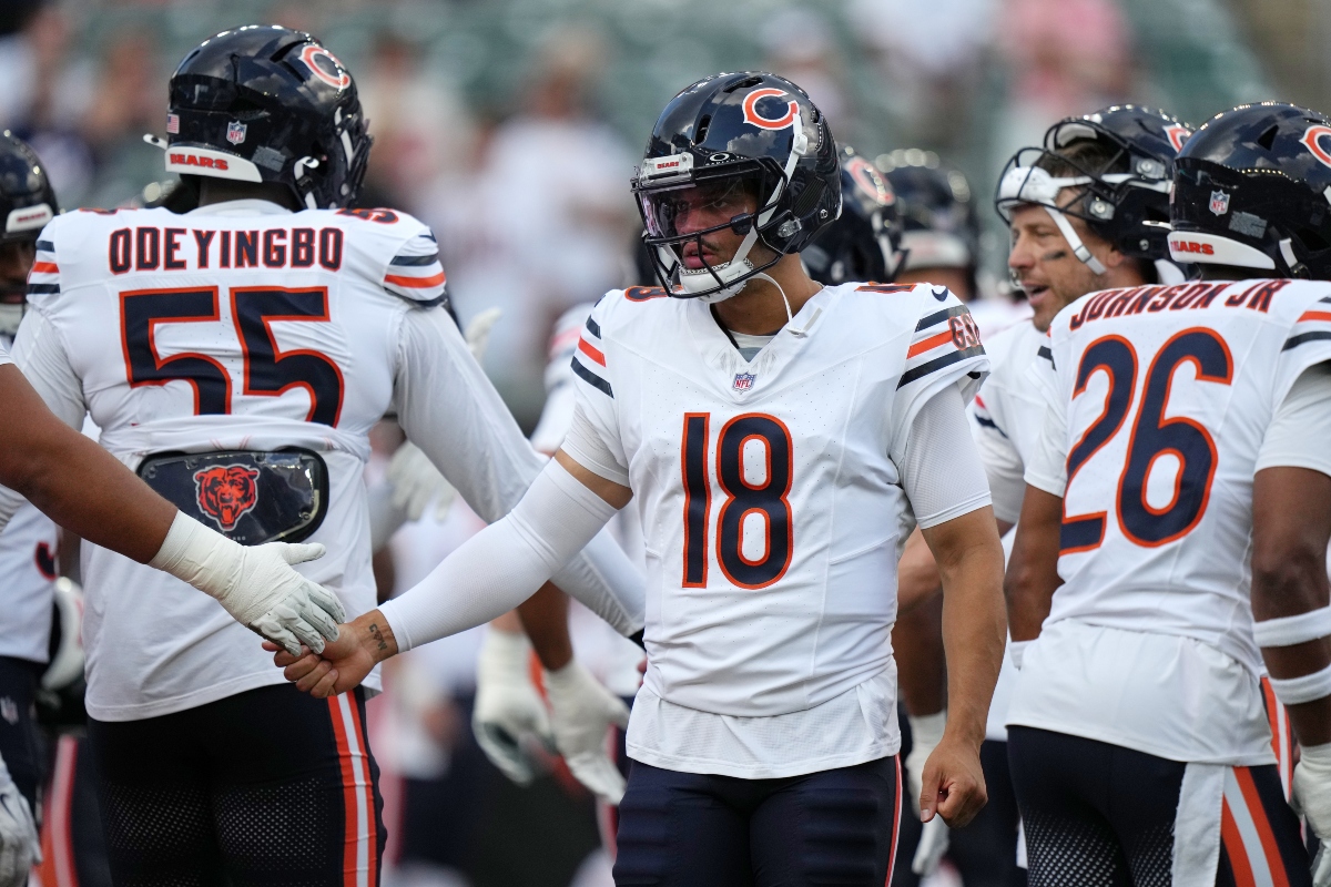 Chicago Bears quarterback Caleb Williams, center, greets players during warm ups before a preseason NFL football game against the Cincinnati Bengals on Saturday, Aug. 22, 2026, in Cincinnati. (AP Photo/Joshua A. Bickel)
