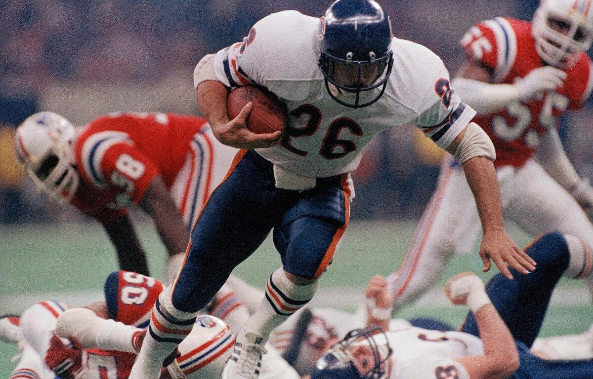 FILE - Chicago Bear's Matt Suhey (26) heads for a touchdown during the NFL Super Bowl 20 football game against the New England Patriots in New Orleans, Jan. 26, 1986. (AP Photo, File)