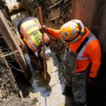 Workers install a copper pipe to replace a lead service line that brings drinking water to homes Tuesday, July 21, 2026, in Chicago. (AP Photo/Alyssa Goodman)