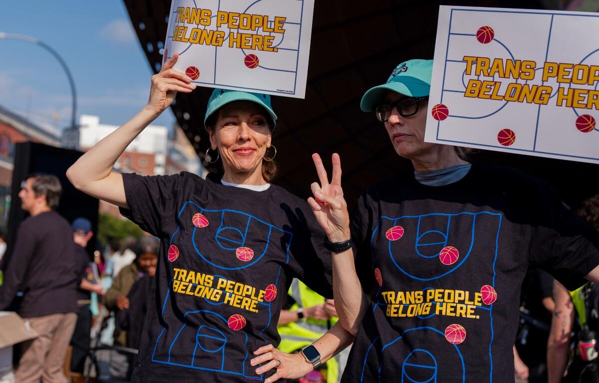 FILE - Demonstrators rally in support of transgender athletes in women's sports outside of Barclay's Center before the WNBA basketball game between the Indiana Fever and the New York Liberty, Aug. 22, 2026, in New York. (AP Photo/Angelina Katsanis, File)