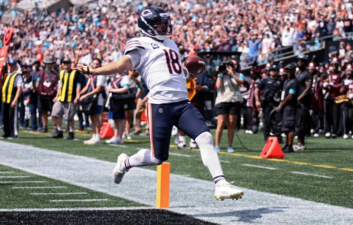 Chicago Bears quarterback Caleb Williams (18) runs to score a touchdown during the first half of an NFL football game, Sunday, Sept. 13, 2026, in Charlotte, N.C. (AP Photo/Scott Kinser)