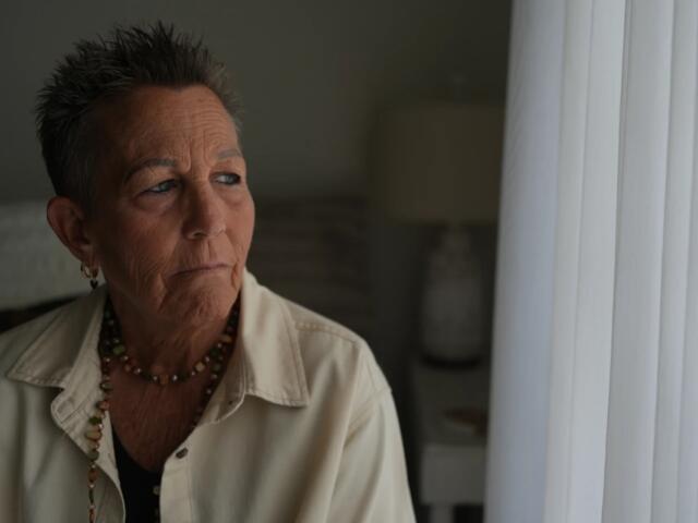 Deb Robertson, a leading advocate for a medical aid-in-dying law named after her in Illinois, pauses during an interview in her home in Lombard, Ill., on Tuesday, Sept. 8, 2026. (AP Photo/Luis Andres Henao)