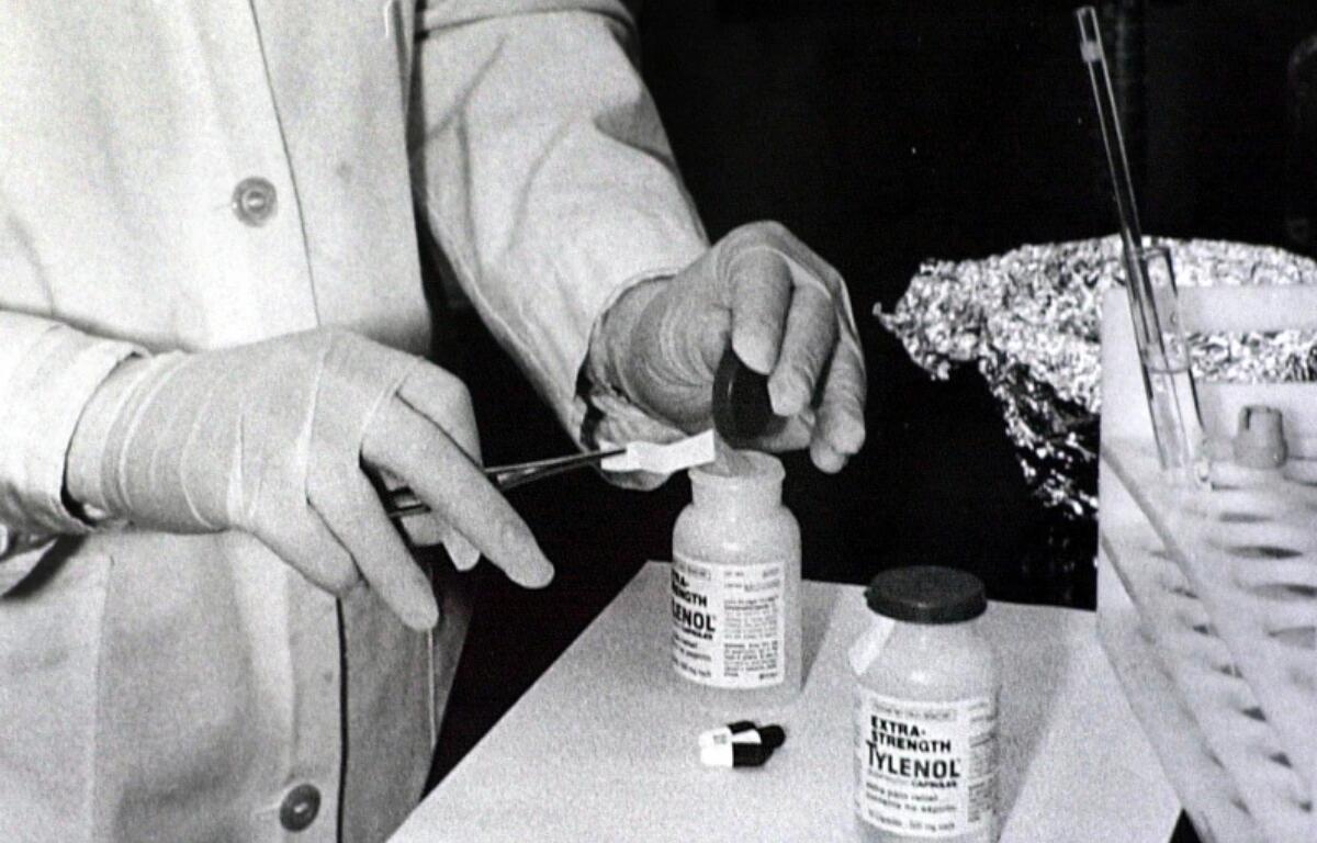 FILE - Bottles of Extra-Strength Tylenol are tested with a chemically treated paper that turns blue in the presence of cyanide at the Illinois Department of Health in Oct. 1982, in Chicago. (AP Photo/John Swart, File)