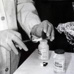 FILE - Bottles of Extra-Strength Tylenol are tested with a chemically treated paper that turns blue in the presence of cyanide at the Illinois Department of Health in Oct. 1982, in Chicago. (AP Photo/John Swart, File)