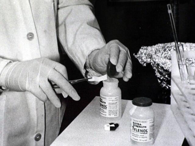 FILE - Bottles of Extra-Strength Tylenol are tested with a chemically treated paper that turns blue in the presence of cyanide at the Illinois Department of Health in Oct. 1982, in Chicago. (AP Photo/John Swart, File)