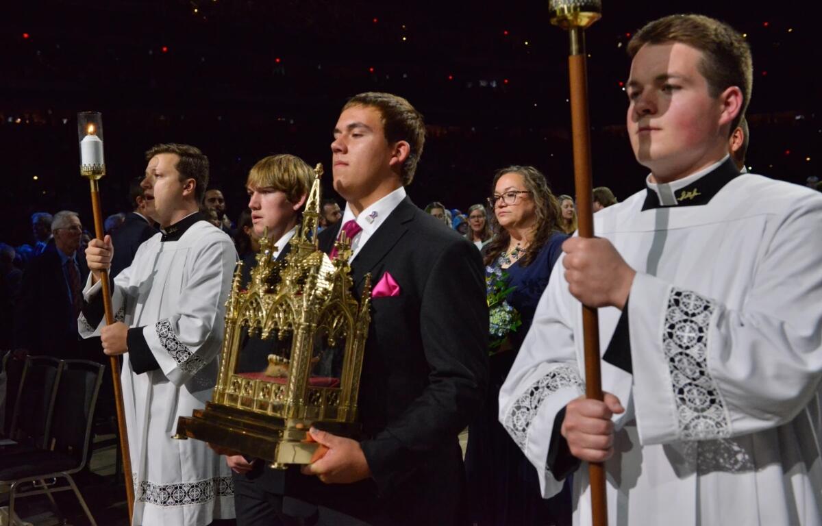 James Fulton Engstrom, center, his mother, Bonnie Engstrom, background center, and other family members present a relic of Archbishop Fulton Sheen during Sheen's beatification at the Dome at America's Center in St. Louis, on Thursday, Sept. 24, 2026. (AP Photo/Kate Munsch)