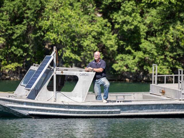 Co-owner of Mermet Springs Glen Faith poses for a portrait on the training boat stationed in the middle of the quarry April 23, 2026, at Mermet Springs in Belknap, Illinois. (Peyton Cook for the Saluki Local Reporting Lab)