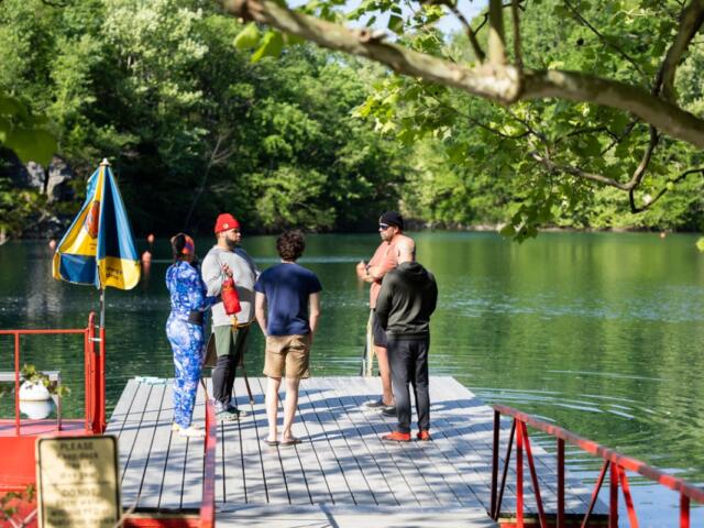 Students and instructors from Louisville dive shop stand together and talk through a dive for an open water class April 25, 2026, at Mermet Springs in Belknap, Illinois. (Peyton Cook for the Saluki Local Reporting Lab)