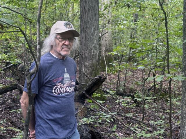 Shawnee conservation activist Mark Donham, 73, of Brookport, hikes within the Burke Branch area of the Shawnee. The protected area backs up to Donham’s 13-acre property, where he has lived since 1980. (Kate McCann, for Capitol News Illinois)