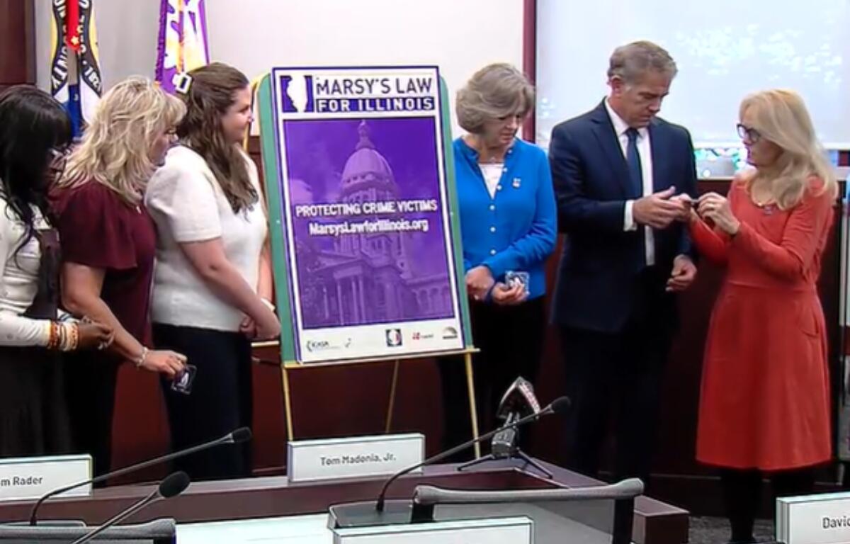 Sangamon County State's Attorney John Milhiser and others take part in a ceremony from the advocates for "Marsy's Law."
