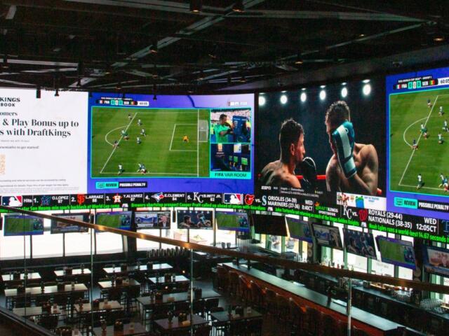 A massive 2,000-square-foot television wraps around the DraftKings Sports Bar at Wrigley Field. (Capitol News Illinois photo by Maggie Dougherty)