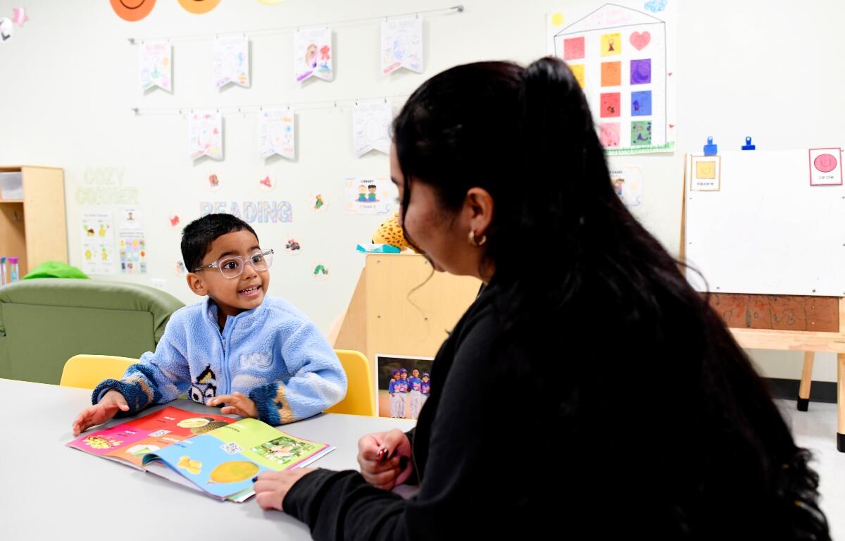 Joanna Isitt, 28, reads with her son, Xavier Rogers, 4, before teaching her Head Start class at Hometown Child Care on Wednesday, Sept. 23, 2026, in Aurora, Ill. (AP Photo/Octavio Jones)
