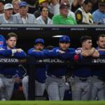 The Chicago Cubs dugout watches in the seventh inning against the San Diego Padres in Game 2 of the National League Wild Card baseball playoff series Wednesday, Sept. 30, 2026, in San Diego. (AP Photo/Gregory Bull)