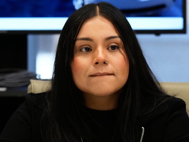 Marimar Martinez, a Chicago woman who was shot by a Border Patrol agent last year, listens to attorney Christopher Parente at a press conference Monday, Oct. 5, 2026, in Chicago. (AP Photo/Nam Y. Huh)