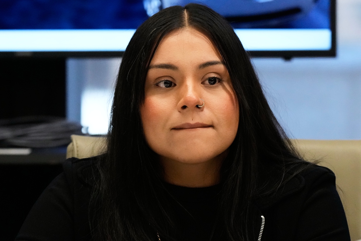 Marimar Martinez, a Chicago woman who was shot by a Border Patrol agent last year, listens to attorney Christopher Parente at a press conference Monday, Oct. 5, 2026, in Chicago. (AP Photo/Nam Y. Huh)