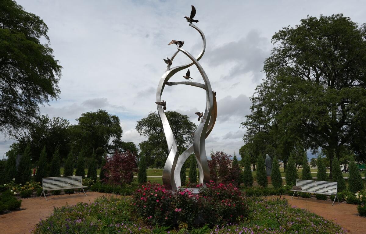 A sculpture of ascending doves is displayed at a memorial for survivors and lives lost to suicide dedicated by the Archdiocese of Chicago at Queen of Heaven Catholic Cemetery in Hillside, Ill., on Wednesday, Sept. 9, 2026. (AP Photo/Luis Andres Henao)