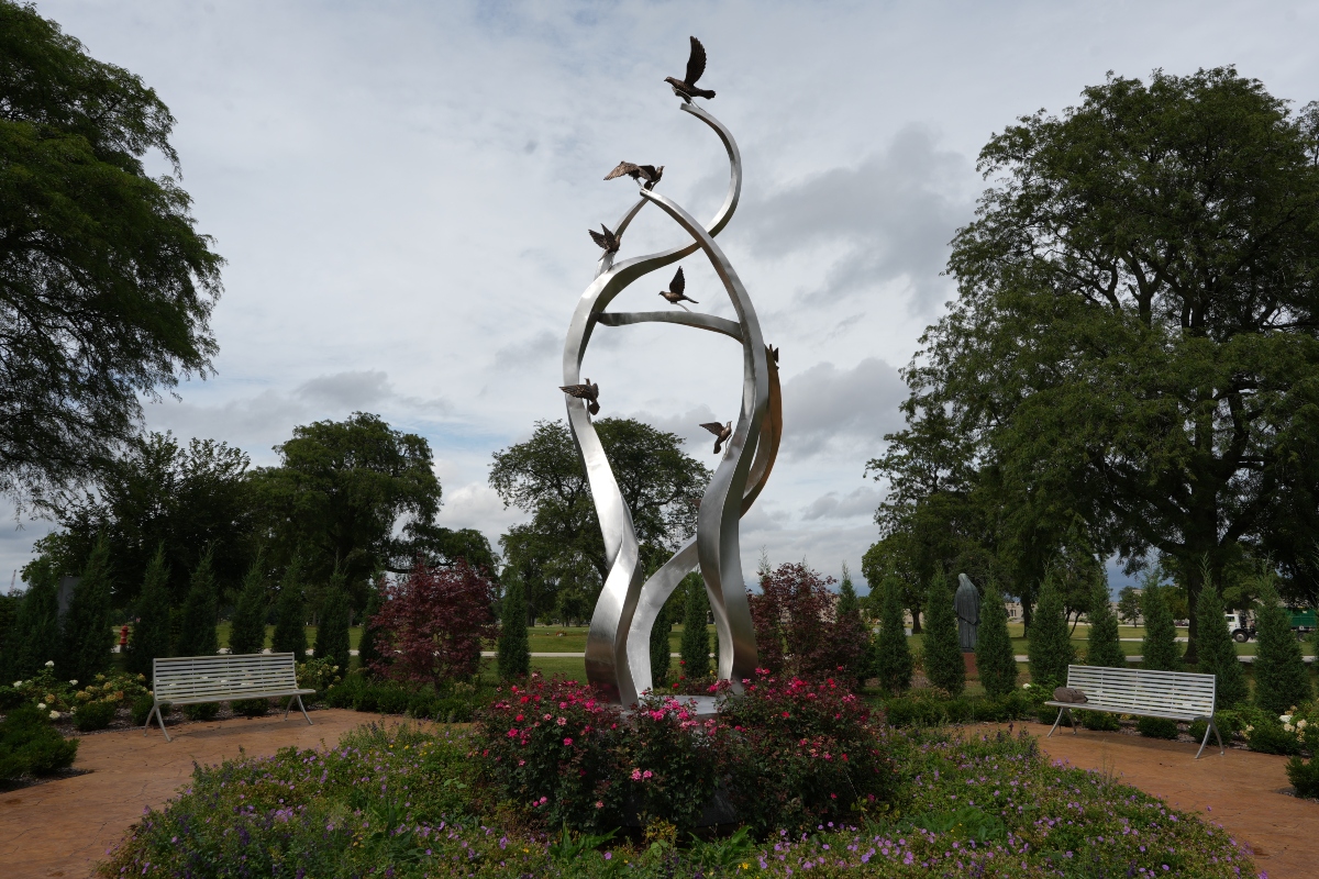 A sculpture of ascending doves is displayed at a memorial for survivors and lives lost to suicide dedicated by the Archdiocese of Chicago at Queen of Heaven Catholic Cemetery in Hillside, Ill., on Wednesday, Sept. 9, 2026. (AP Photo/Luis Andres Henao)
