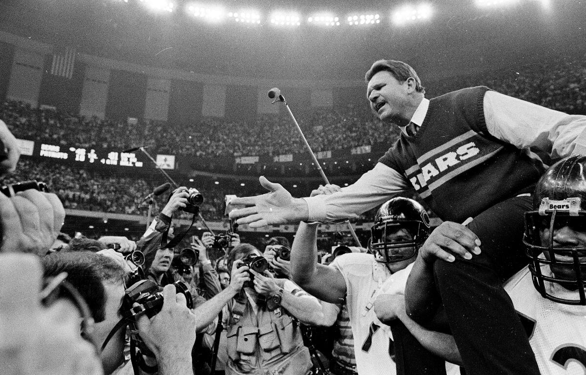 FILE - In this Jan. 26, 1986 file photo shows, Chicago Bears coach Mike Ditka reaches out to shake hands with New England Patriots coach Raymond Berry after the Bears won the NFL football Super Bowl XX game in New Orleans. (AP Photo/File)