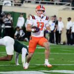 Illinois wide receiver Hudson Clement (13) scores on a touchdown pass against Michigan State on the first play of overtime during an NCAA college football game, Saturday, Oct. 10, 2026, in East Lansing, Mich. (AP Photo/Lon Horwedel)