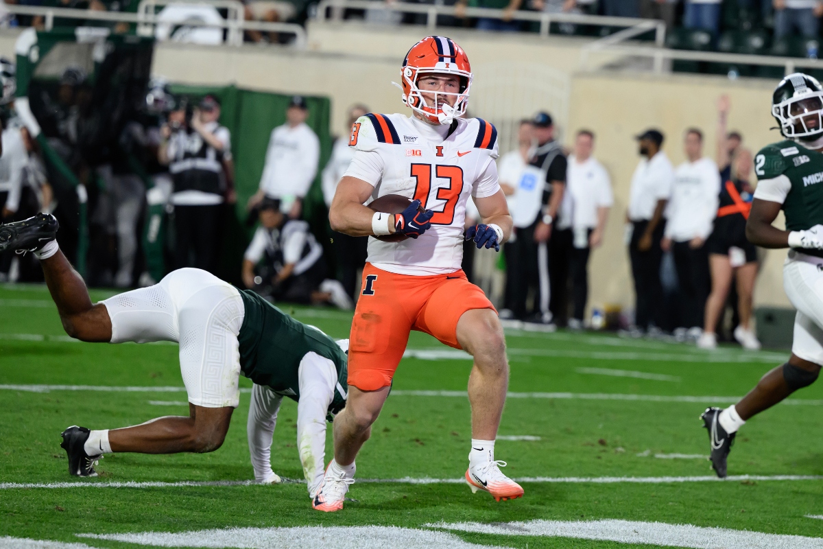 Illinois wide receiver Hudson Clement (13) scores on a touchdown pass against Michigan State on the first play of overtime during an NCAA college football game, Saturday, Oct. 10, 2026, in East Lansing, Mich. (AP Photo/Lon Horwedel)
