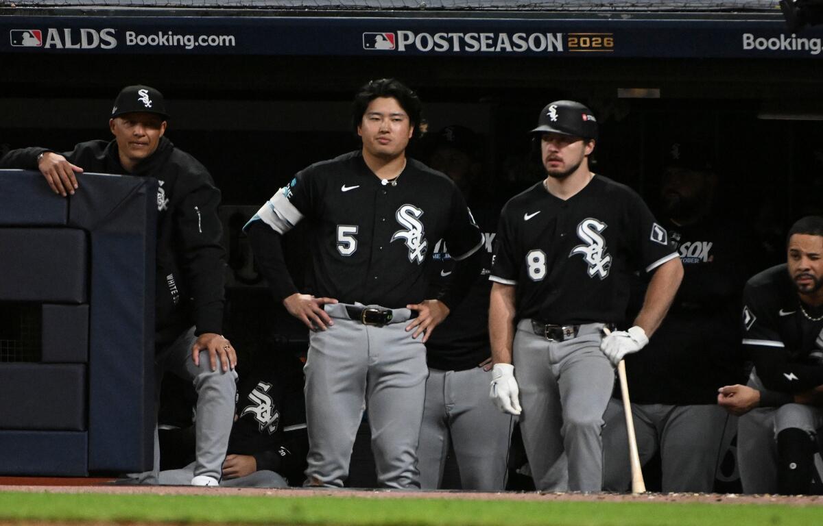 Chicago White Sox first baseman Munetaka Murakami (5) and catcher Kyle Teel (8) watch from the dugout during the eighth inning of Game 5 of baseball's American League Division Series against the Cleveland Guardians, Saturday, Oct. 10, 2026, in Cleveland. (AP Photo/Phil Long)