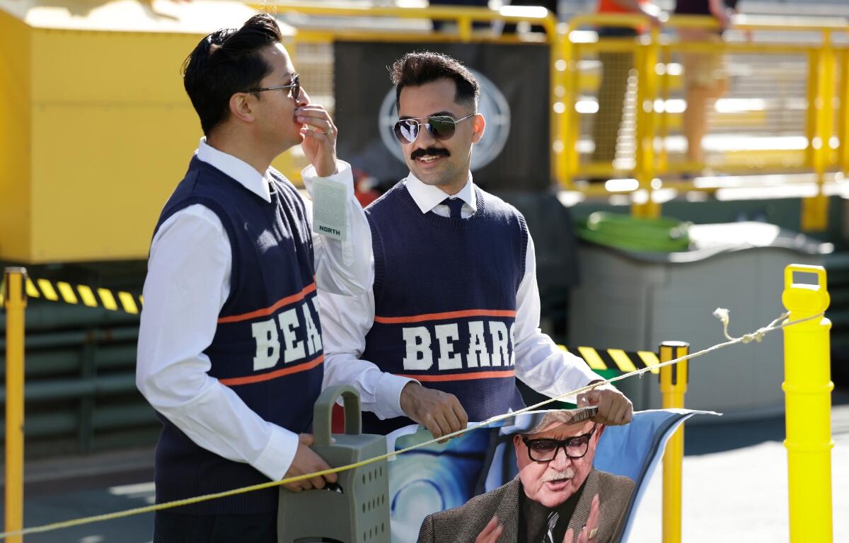 Chicago Bears fans dress up as Mike Ditka before an NFL football game against the Green Bay Packers in Green Bay, Wis., Sunday, Oct. 11, 2026. (AP Photo/Matt Ludtke)