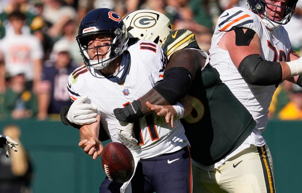 Chicago Bears' Case Keenum fumbles as he is hit by Green Bay Packers' Devonte Wyatt during the second half of an NFL football game in Green Bay, Wis., Sunday, Oct. 11, 2026. (AP Photo/Nam Huh)