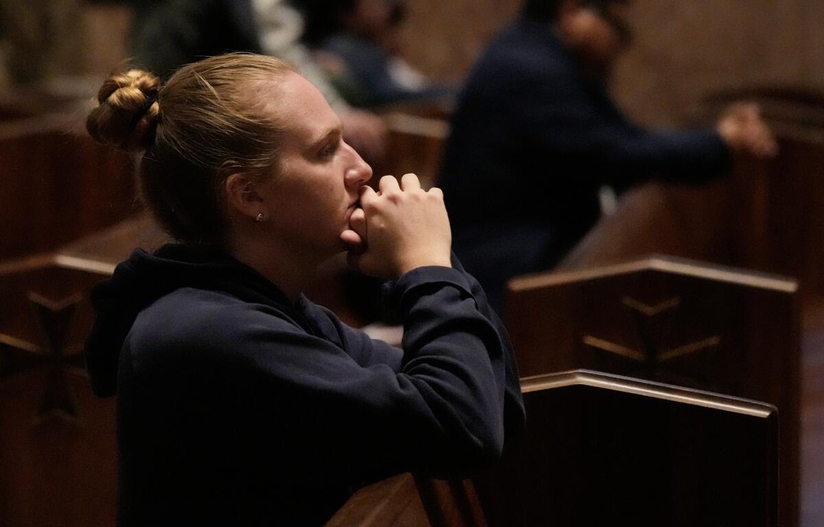 A person prays at a votive mass for Pope Leo XIV in light of his lung cancer diagnosis at Holy Name Cathedral in Chicago, Wednesday, Oct. 14, 2026. (AP Photo/Nam Y. Huh)