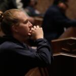 A person prays at a votive mass for Pope Leo XIV in light of his lung cancer diagnosis at Holy Name Cathedral in Chicago, Wednesday, Oct. 14, 2026. (AP Photo/Nam Y. Huh)