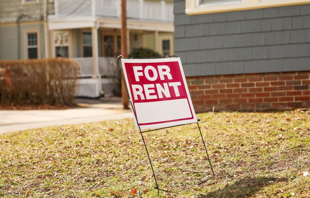 For sale for rent sign in front of home showing economic signs of increased inflation and mortgage rates depicting housing market crisis and financial troubles